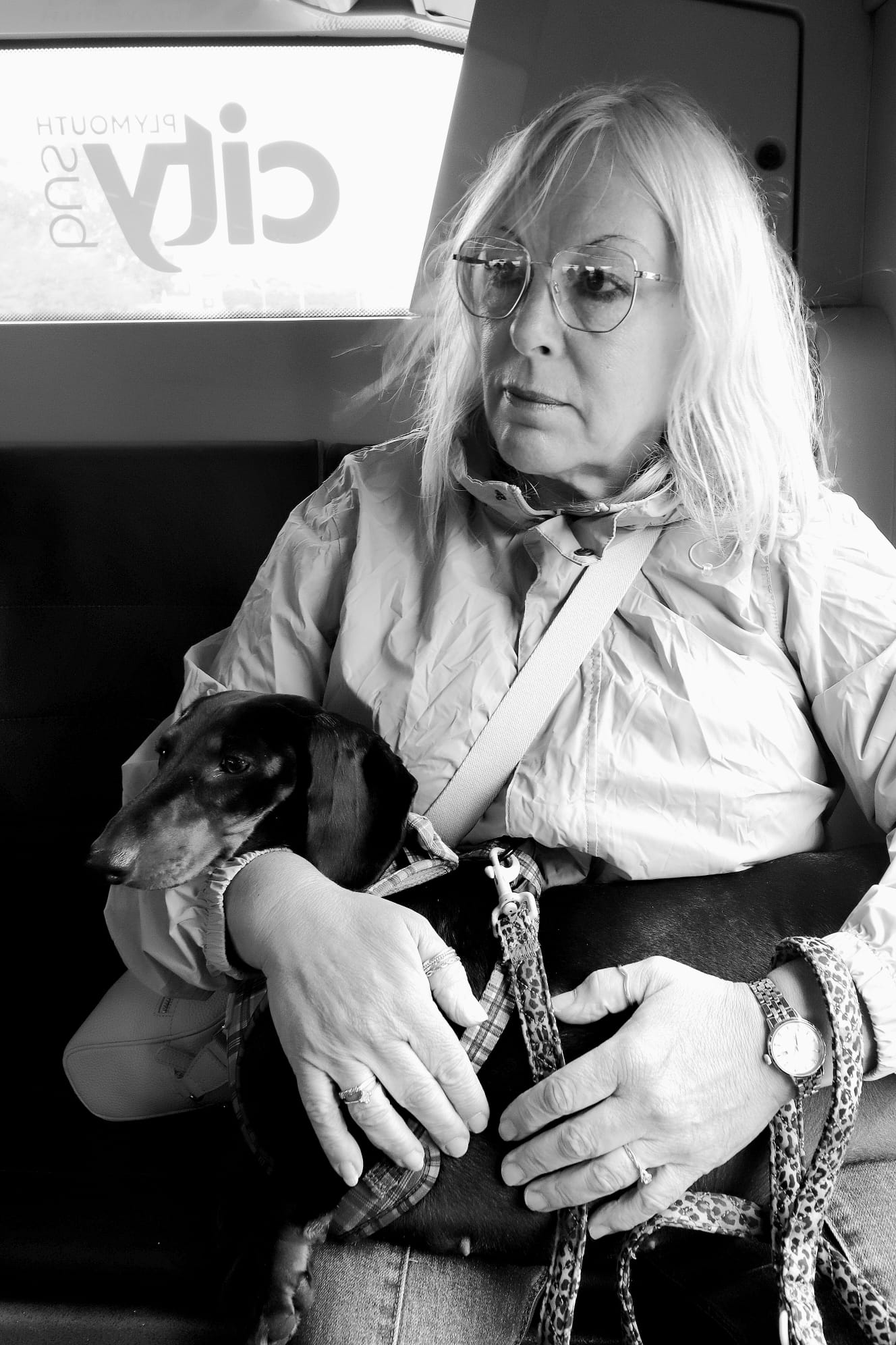 Photograph of Lady sat on a Bus with her dog
